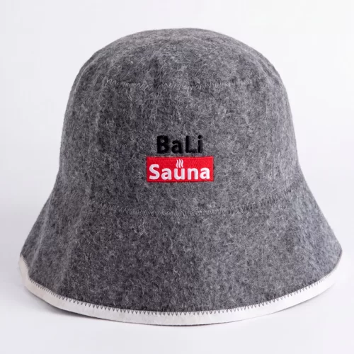 Gray felt bucket hat with a white trim along the bottom edge and a red 'Sauna' logo patch on the front, with 'BaLi' embroidered above.
